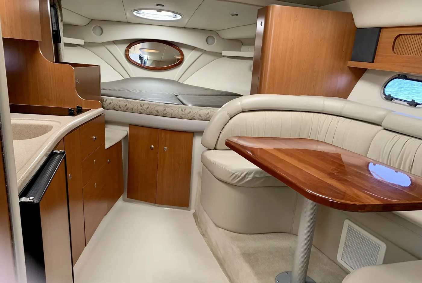 Interior cabin of a 37-foot Four Winns yacht — galley, berth and dining table
