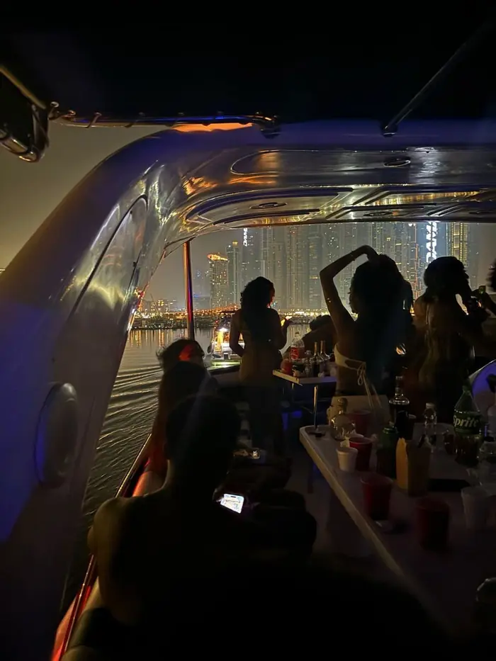 Party on a boat at night with the skyline